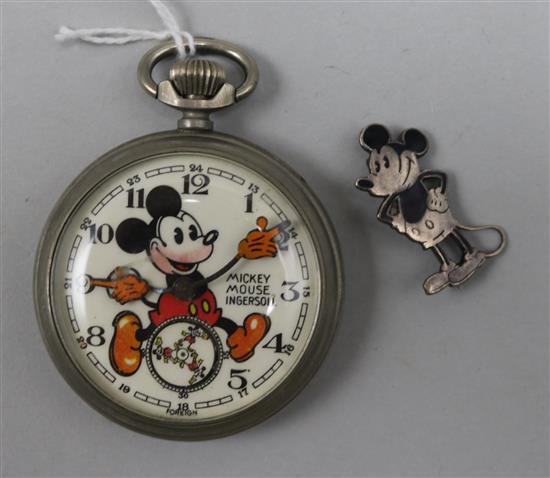 A 1930s novelty chrome cased Ingersoll Mickey Mouse pocket watch with pink beard and a Mickey Mouse white metal brooch.